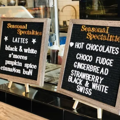 Two felt letterboards listing seasonal lattes and hot chocolates
